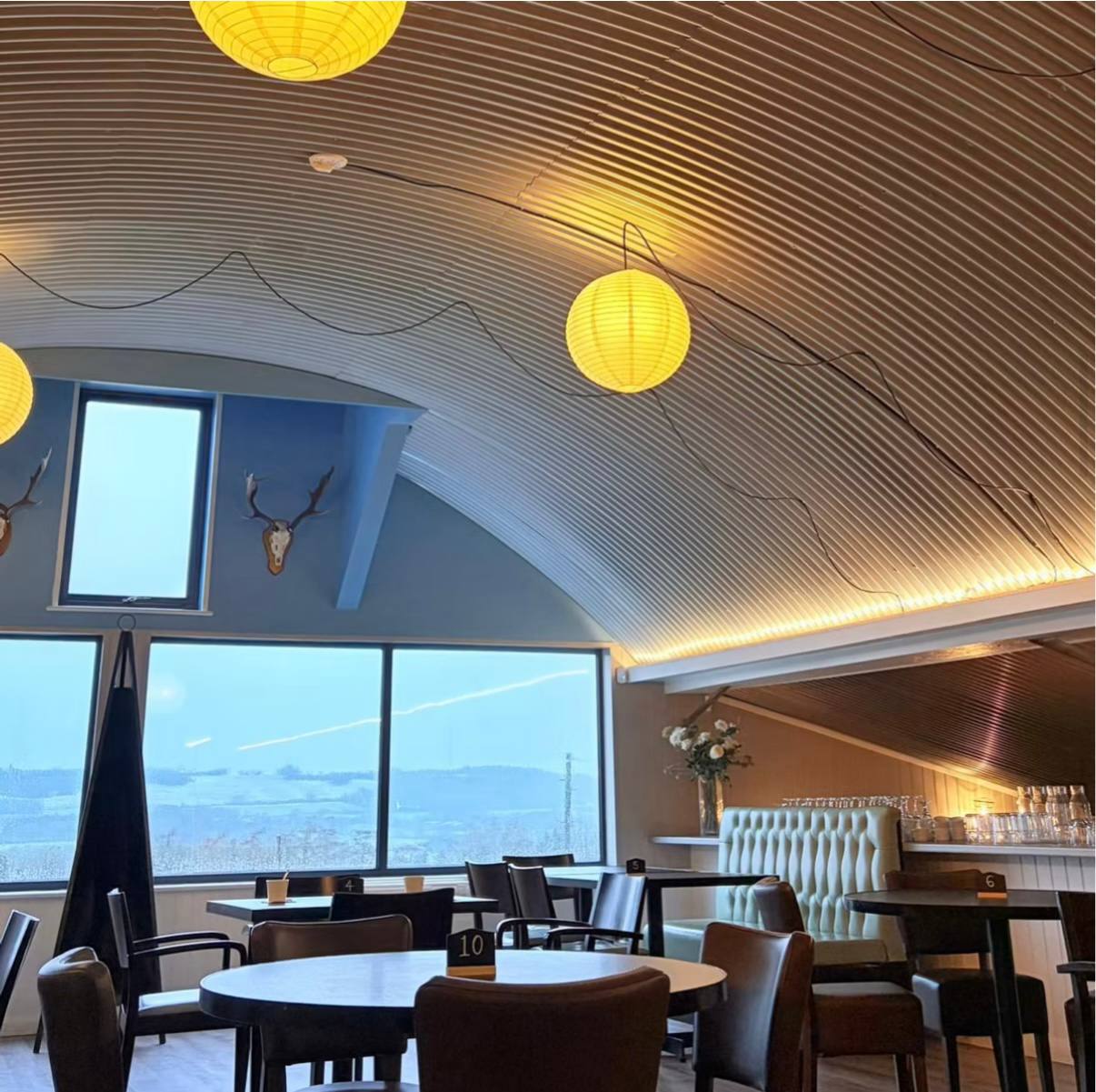 Chart Farm Restaurant interior with countryside views, set tables and warm natural light